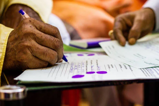 hand of an old man writing important legal document